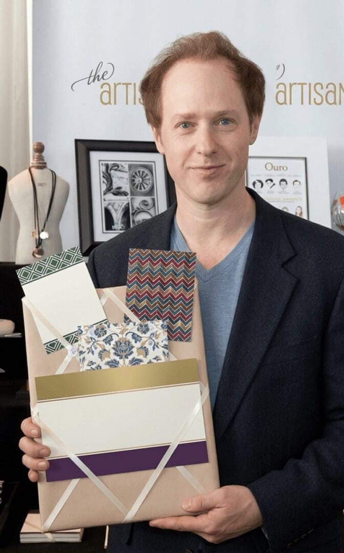 Man holding decorative paper samples