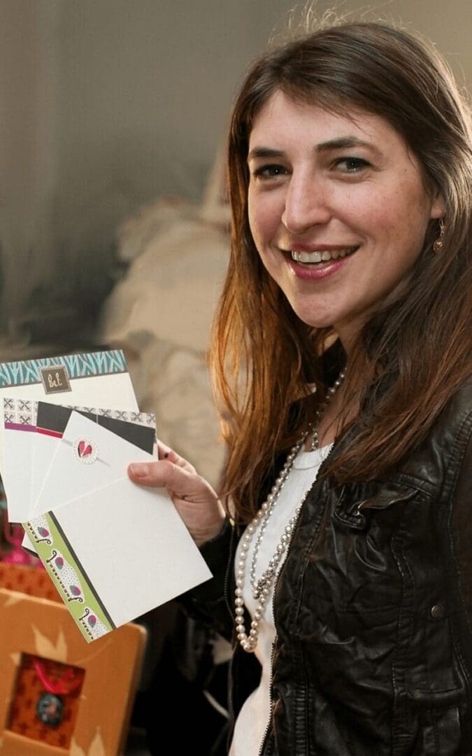 Woman holding decorative stationery cards